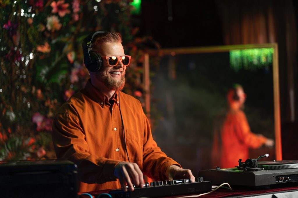 DJ playing music at colorful floral event