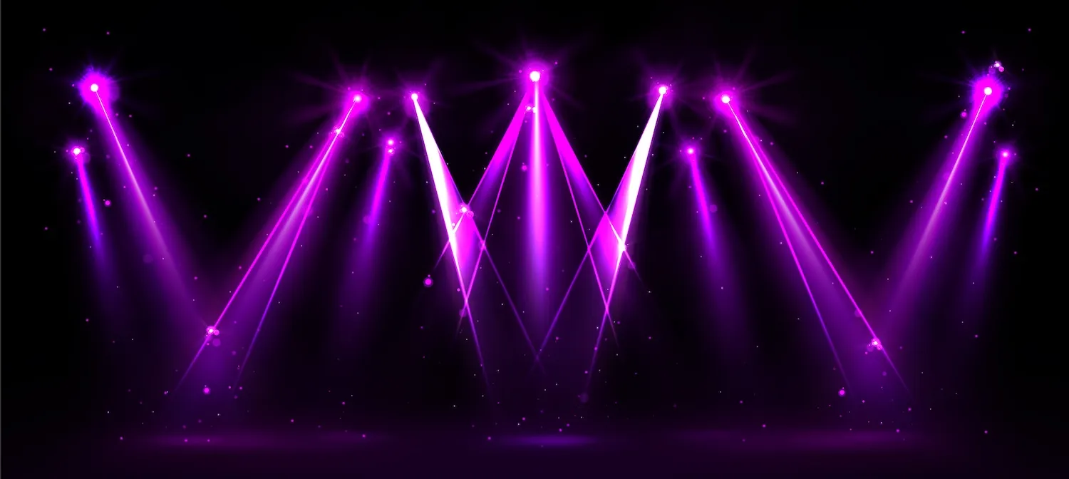 Purple stage lights illuminating dark background