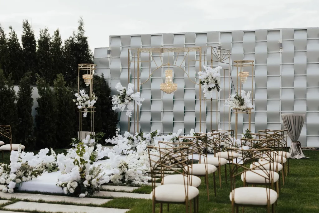 Elegant outdoor wedding ceremony setup with white flowers