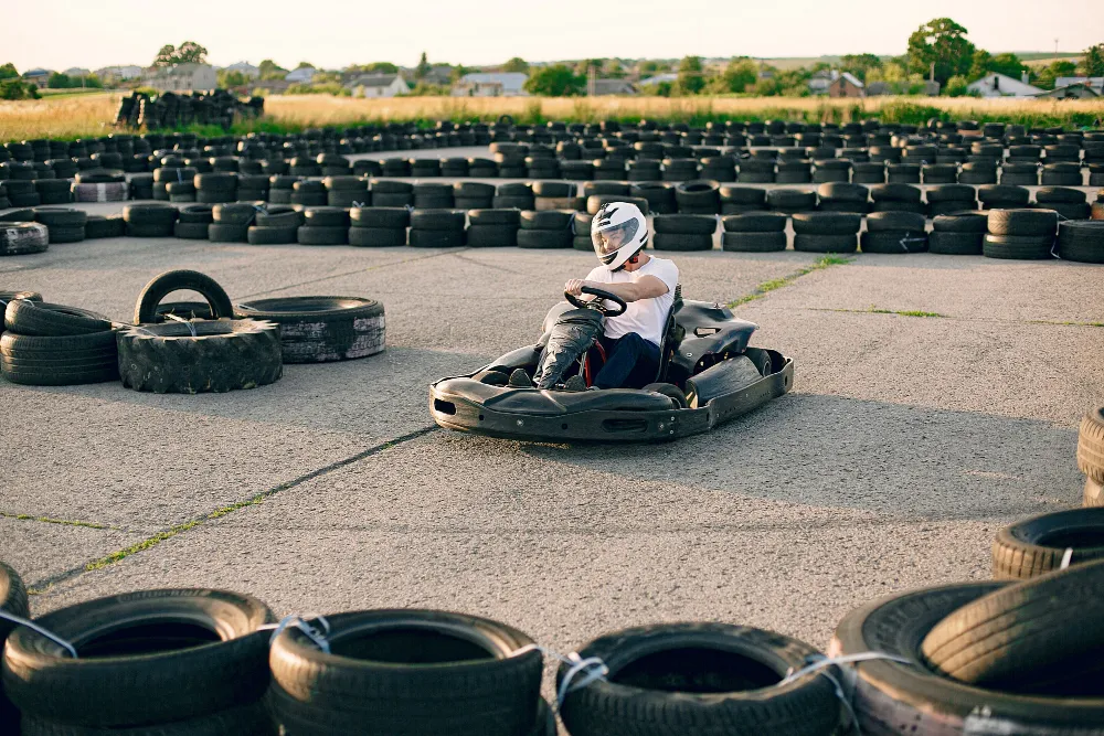Person driving go-kart on outdoor track