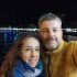 julio resenas whitelion Couple smiling by waterfront at night.